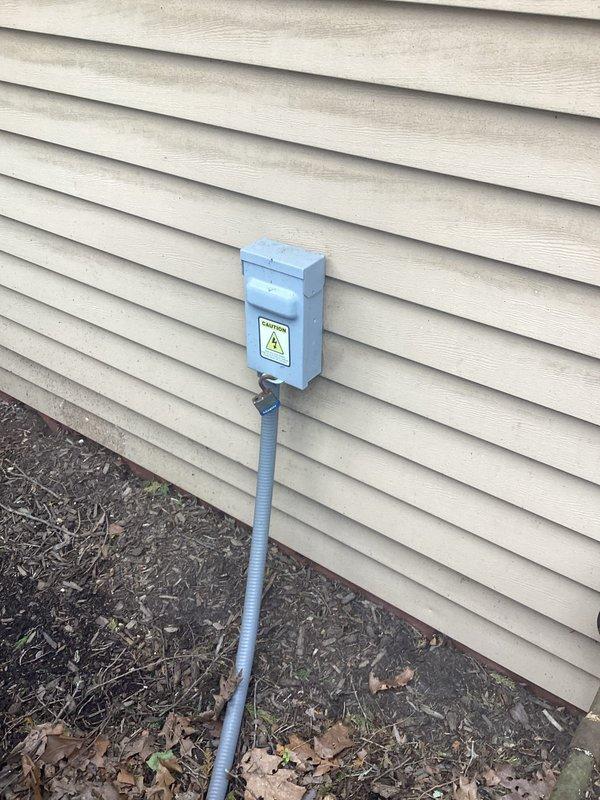 Performed scheduled maintenance on residential electrical system and replaced backup battery in exterior utility enclosure. Accessed attic space to inspect wiring connections and verify proper cable routing through ceiling joists. All components tested and confirmed operational upon completion.