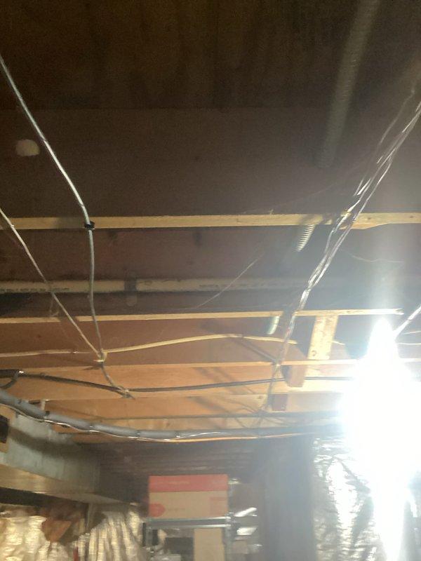 Performed scheduled maintenance on residential electrical system and replaced backup battery in exterior utility enclosure. Accessed attic space to inspect wiring connections and verify proper cable routing through ceiling joists. All components tested and confirmed operational upon completion.