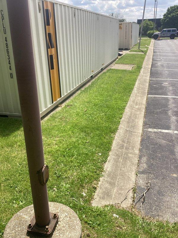 Conducted site assessment for installation of light fixture on exterior flagpole at commercial facility. Evaluated existing pole structure, concrete base mounting, electrical routing requirements from building to pole location across parking lot and landscaped areas, and determined specifications needed for proper illumination and code-compliant installation.