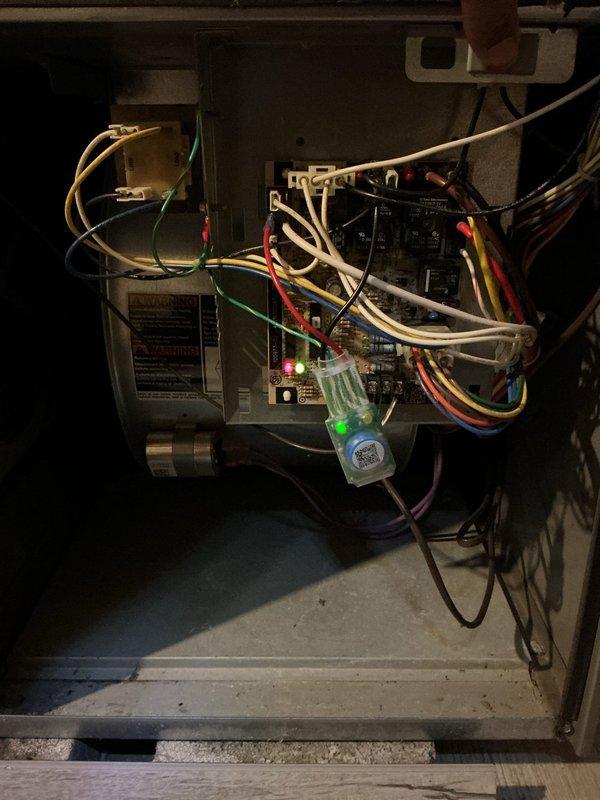 Responded to service call for furnace making noise at residential property. Upon arrival, performed diagnostic inspection of heating system. Removed access panels and examined internal components including blower motor assembly, gas valve, control board, and electrical connections. Verified system operation and observed LED indicators showing unit was powered and functional. Inspected blower motor for unusual sounds or mechanical issues as previously suggested by another contractor. Examined wiring connections throughout unit, noting various wire runs to control board and gas valve assembly. Documented equipment condition through photography for service records. All major components including blower motor, control board, and gas valve were inspected and operational at time of service.