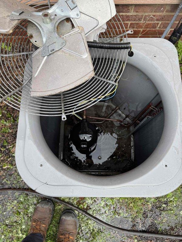 # HVAC Maintenance - Cooling Systems

Performed comprehensive seasonal cooling maintenance on two HVAC systems as part of preventative maintenance program. Inspected outdoor condenser unit, removing top grille to access internal components including compressor motor, condenser coils, and fan blade assembly. Verified proper operation of all mechanical components and checked refrigerant levels. Examined indoor air handler equipment including condensate management system with expansion tank and condensate pump. Noted significant rust and corrosion on pump housing and metal fittings, indicating prolonged moisture exposure. Verified drainage system functionality and inspected all electrical connections and wiring. Documented equipment condition through photographic records. Both systems operational upon completion of maintenance inspection.