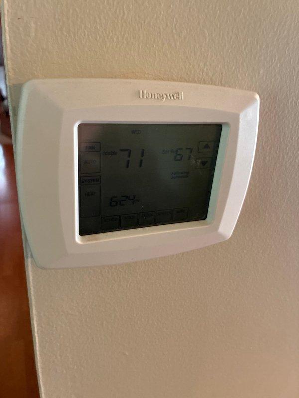 Conducted comprehensive HVAC system evaluation for full replacement options at residential property. Assessed existing vertical air handler unit located in interior utility closet with bi-fold louvered door access. Documented current equipment configuration including ductwork connections and unit specifications. Evaluated existing Honeywell programmable thermostat showing operational status at time of visit. Provided customer with complete system replacement options and specifications for new equipment installation. Photographed existing equipment and control locations for proposal documentation.