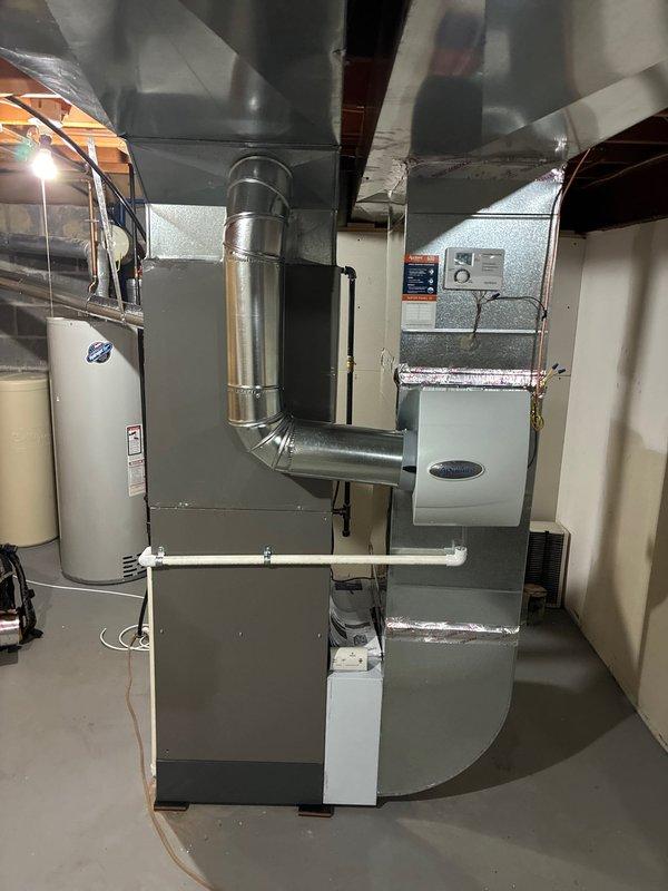 Completed full HVAC system installation including Lennox 80% efficiency furnace, air conditioning unit, chimney liner, and humidifier in basement mechanical room. All equipment professionally mounted, connected to new metallic ductwork with proper transitions and plenums, and tested for optimal performance. System commissioned and operational with all components functioning to manufacturer specifications.