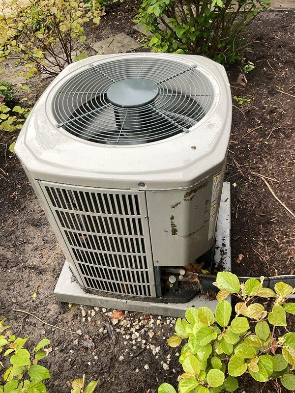 Completed preventative maintenance service on two residential air conditioning systems. Performed comprehensive inspection of both outdoor condensing units, including a white-housed unit and a Trane condenser with gray/green casing. Inspected fan motors, compressors, and electrical components on both systems. Checked refrigerant levels, verified proper operation of capacitors, and examined all electrical connections for security and signs of wear. Cleaned condenser coils and removed debris accumulation from base areas and surrounding concrete pads. Verified proper airflow through louvered panels and fan guards. Both systems tested and confirmed operational with normal performance parameters.