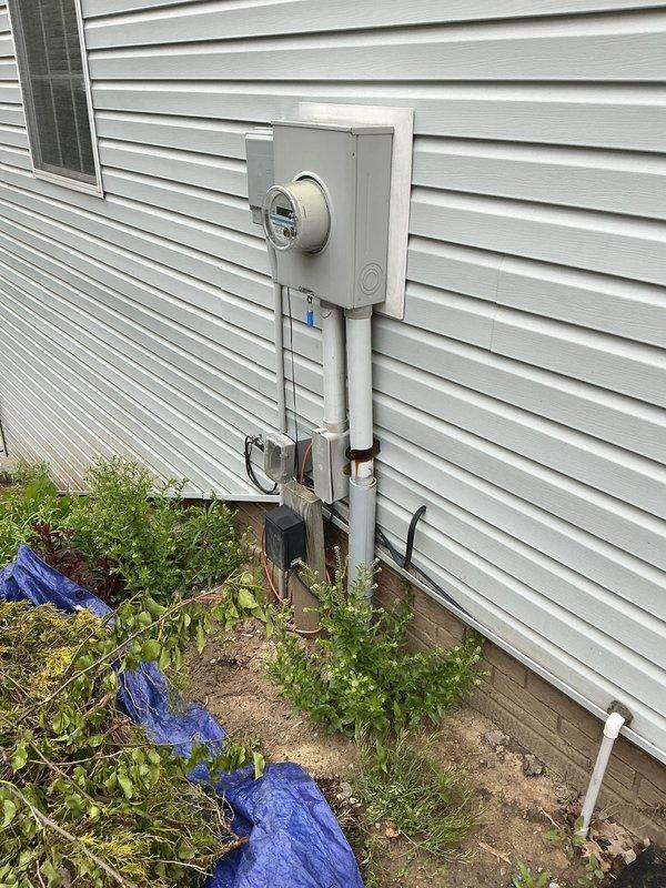 Completed comprehensive electrical inspection of residential service entrance and main distribution panel. Documented exterior meter installation with PVC conduit routing and photographed main breaker panel showing dual-column circuit breaker configuration with proper wire management and color-coded branch circuit wiring.