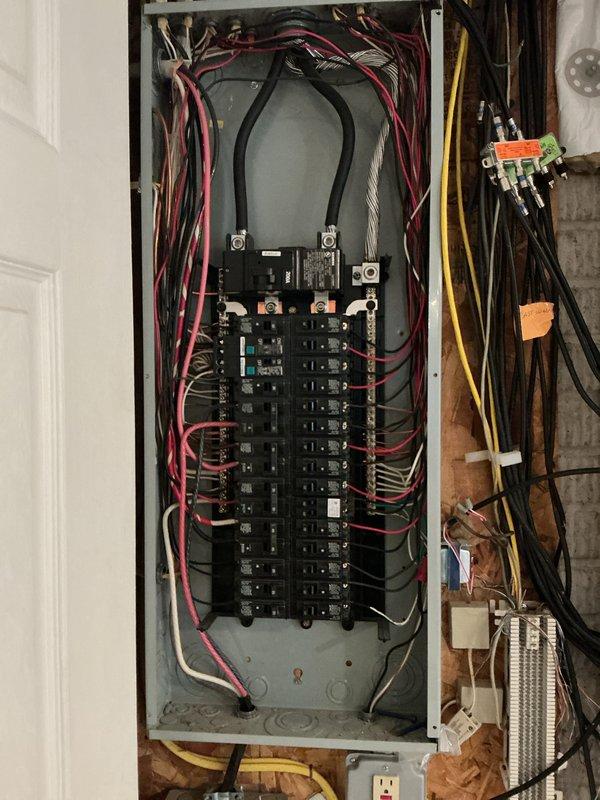 Completed comprehensive electrical inspection of residential service entrance and main distribution panel. Documented exterior meter installation with PVC conduit routing and photographed main breaker panel showing dual-column circuit breaker configuration with proper wire management and color-coded branch circuit wiring.