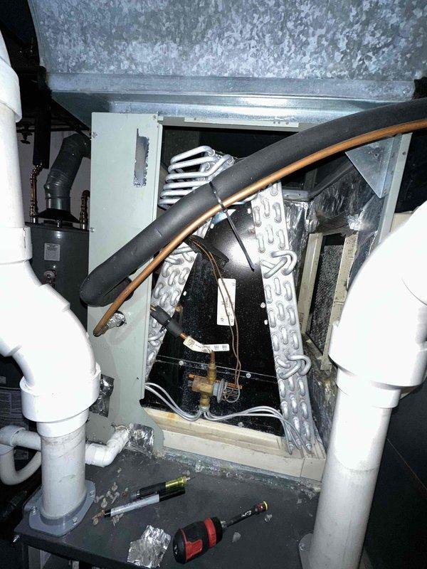 Completed comprehensive heating and cooling maintenance on two HVAC systems, including inspection of attic-mounted air handler with refrigerant lines, electrical connections, and condensate drainage components. Performed electrical diagnostics on outdoor condensing unit using digital multimeter to verify proper system operation and component functionality. All systems tested and confirmed operating within normal parameters.