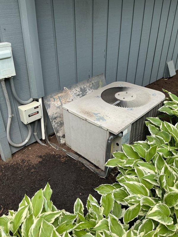 Responded to no cooling complaint on residential air conditioning system. Upon arrival, performed visual inspection of outdoor condenser unit, which showed signs of age and weathering with accumulated dirt and debris on exterior surfaces. Unit appeared operational but customer reported inadequate cooling performance. Documented equipment condition through photographs for service records.
