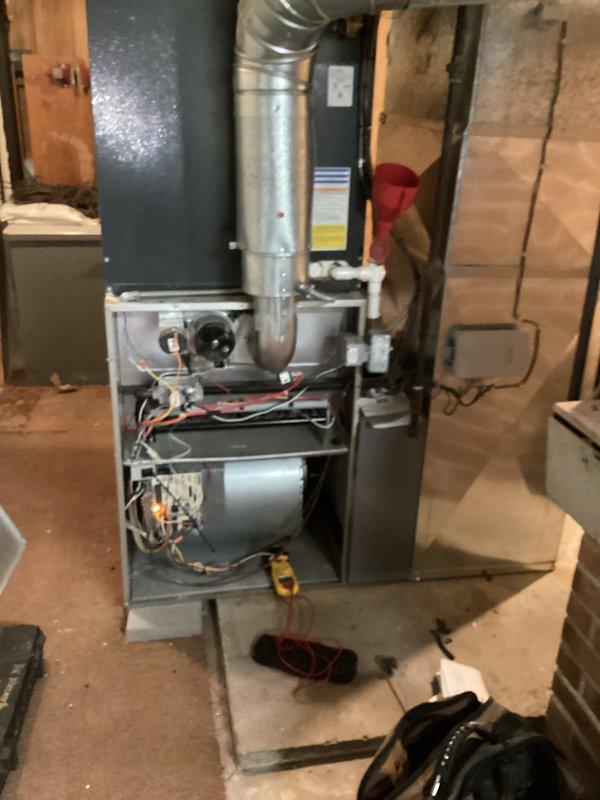 Completed routine cooling maintenance on residential HVAC system, including inspection of furnace components, blower motor, gas burners, and control mechanisms. Inspected condensate drainage system with red funnel collection point and verified proper operation of PVC discharge piping. Customer requested quote for replacement of existing smart thermostat with standard non-programmable thermostat.