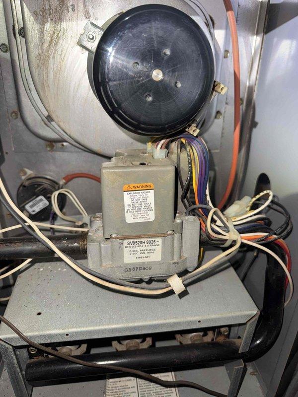 Responded to no communication issue between thermostat and furnace unit. Inspected Goodman model CG80UA0752D12A-1 furnace and examined gas valve assembly, pressure switch, and control wiring connections. Verified proper wiring terminations at gas valve model SVR5204 6028 and confirmed all low-voltage connections were secure to restore thermostat communication with the heating system.