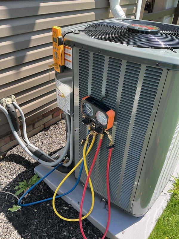 Completed seasonal AC start-up and warranty inspection on residential split system. Connected manifold gauges to outdoor condensing unit, verified refrigerant pressures and system operation, and inspected pleated air filter in indoor air handler. All components functioning properly with no issues identified during commissioning process.