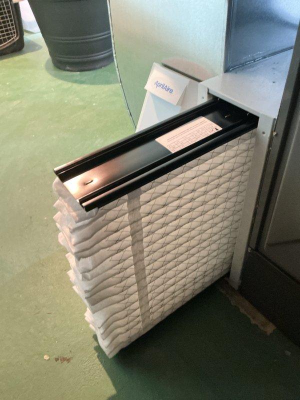 Completed seasonal AC start-up and warranty inspection on residential split system. Connected manifold gauges to outdoor condensing unit, verified refrigerant pressures and system operation, and inspected pleated air filter in indoor air handler. All components functioning properly with no issues identified during commissioning process.