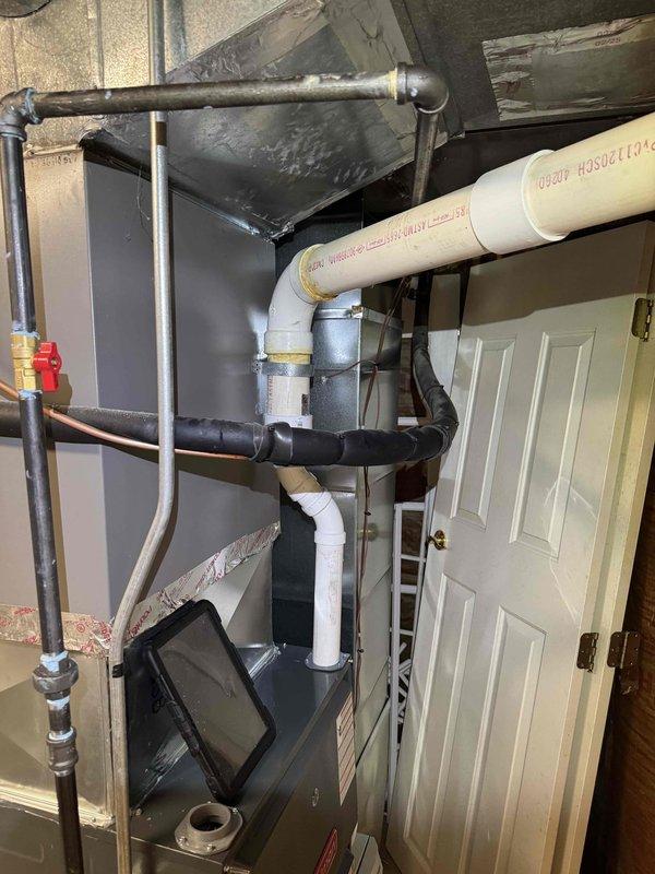 Responded to callback regarding two leaks on recently installed furnace system. Upon inspection, identified issues with condensate drainage piping connections. Verified PVC condensate drain line installation, checked all joints and fittings for proper sealing, and inspected connections at furnace discharge point. Examined ductwork connections to ensure proper sealing at furnace plenum. Tightened and resealed affected pipe joints, verified proper slope on condensate lines for drainage, and tested system operation to confirm leaks were resolved. All connections now secure with no active leaks detected during test cycle.