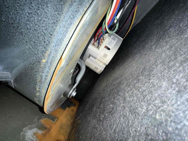Completed routine HVAC cooling system maintenance including inspection of blower wheel assembly and electrical connections. The blower wheel and fan blades showed normal operational wear with minor dust accumulation, and all electrical wiring at the control module was verified secure with proper connections intact.