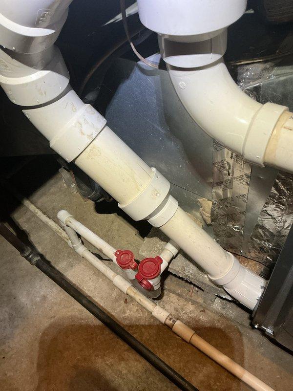 Completed comprehensive cooling system maintenance inspection. Examined and tested run capacitor, verified proper electrical connections and terminal integrity with multi-colored wire leads securely fastened. Inspected condensate drain line system in crawlspace, confirmed PVC drainage piping configuration and shut-off valves functioning properly. All components operating within normal parameters, system ready for cooling season.