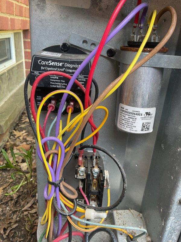 Completed comprehensive cooling system maintenance on residential HVAC unit. Performed inspection of outdoor condensing unit electrical components including CoreSense compressor diagnostic device, capacitor connections, and control wiring; verified all electrical connections were secure and properly terminated. Inspected indoor air handling equipment and ductwork in mechanical room, confirmed proper mounting and clearances of all components. System tested and operating within normal parameters.
