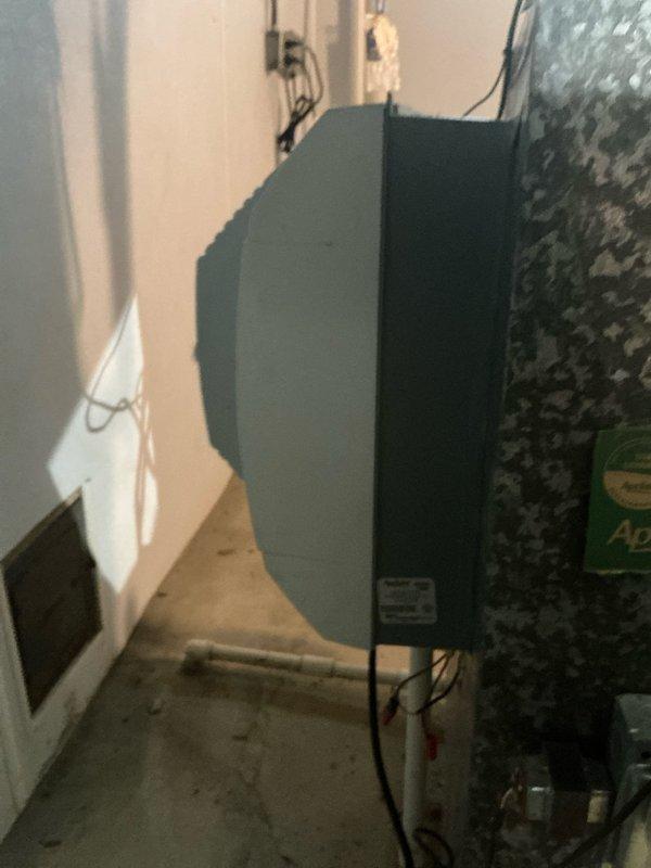 Conducted site evaluation for potential mini split installation above garage area. Inspected existing HVAC system in basement utility room, documenting current furnace unit with accessible air filter housing showing normal operational wear and dust accumulation. Assessed mechanical room layout and electrical infrastructure to determine feasibility of adding ductless mini split system as supplemental cooling/heating solution for garage space.