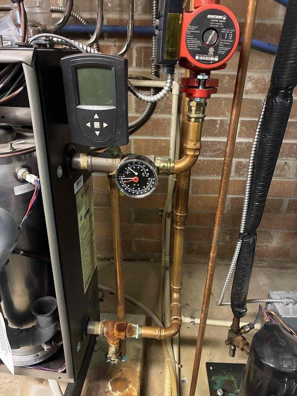 Returned to site to replace failed igniter on boiler system and repair leaking pipes in vicinity of boiler. Upon inspection, identified severely corroded pressure relief valve with significant mineral buildup and rust at threaded connections, which was the source of active leaking. Replaced defective igniter to restore proper boiler ignition sequence. Addressed multiple pipe leaks by replacing corroded valve assembly and repairing compromised copper piping connections with new brass fittings. System tested and verified operational with no further leaks detected at completion.