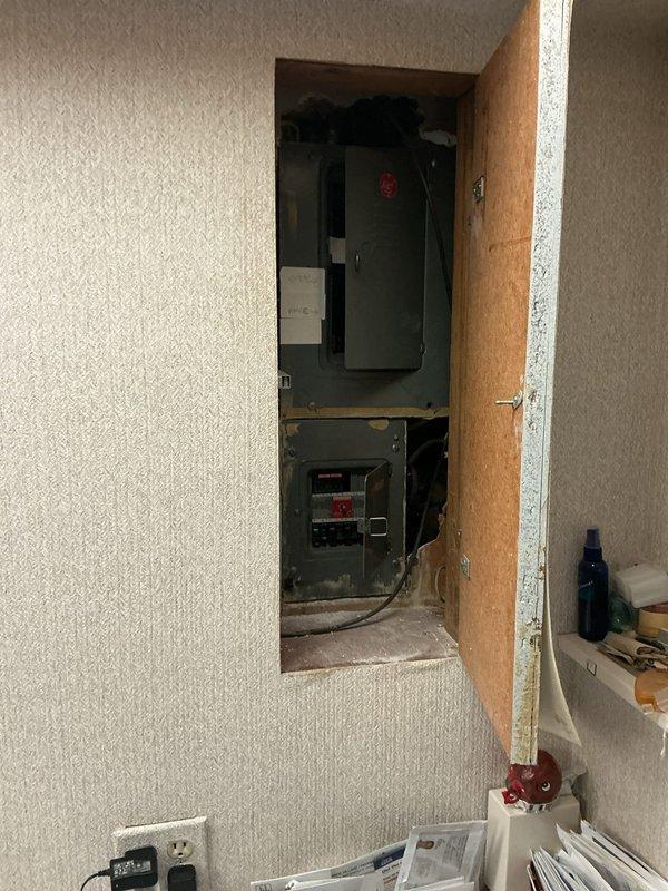 Completed comprehensive electrical inspection of residential property. Documented main electrical service panels located in wall-mounted access compartment, including primary and secondary breaker panels with proper identification markings. Inspected basement utility area electrical systems, including wiring runs along mechanical room walls and connections to plumbing infrastructure. All electrical components photographed for record-keeping purposes, with no immediate deficiencies noted during visual assessment.