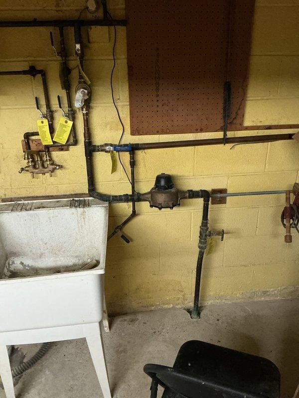 Completed comprehensive electrical inspection of residential property. Documented main electrical service panels located in wall-mounted access compartment, including primary and secondary breaker panels with proper identification markings. Inspected basement utility area electrical systems, including wiring runs along mechanical room walls and connections to plumbing infrastructure. All electrical components photographed for record-keeping purposes, with no immediate deficiencies noted during visual assessment.