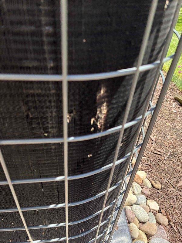 Completed comprehensive cooling system maintenance on outdoor condenser unit. Performed visual inspection revealing moderate fin damage with bent and compressed sections, along with corrosion and rust deposits on condenser coil surfaces. Assessed hail damage to fins and protective grille, documented equipment condition with photographs for repair quotation purposes.