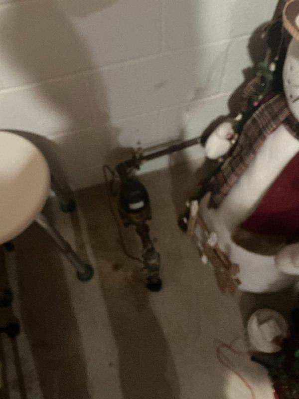 Completed comprehensive whole home electrical inspection of residential property. Documented mechanical room and basement areas, examining electrical service equipment, water heater installation, HVAC system components, and associated wiring. Photographed copper plumbing lines, metallic ductwork, gas piping with shutoff valves, and overhead electrical conduit routing through exposed ceiling joists to assess overall system condition and code compliance.