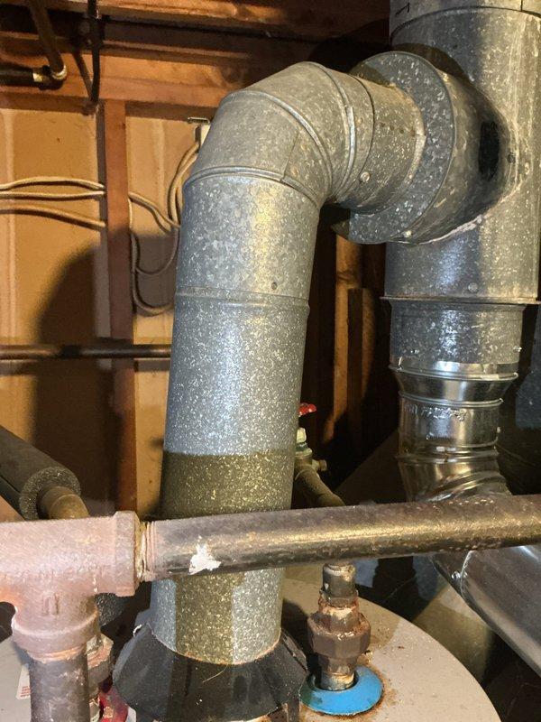Responded to service call regarding improper venting configuration between water heater and HVAC system sharing common vent stack, as identified during property appraisal inspection. Assessed existing galvanized ductwork and venting arrangement in mechanical space where furnace and air conditioning system were previously installed. Performed necessary repairs to furnace duct tube connections and corrected venting issues to ensure proper exhaust separation and code compliance for both water heater and HVAC equipment.