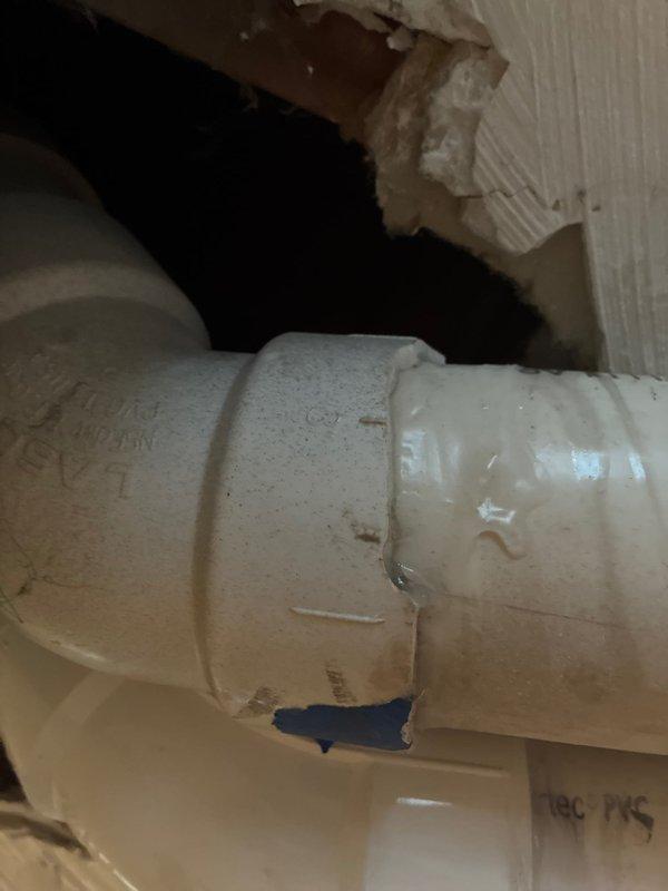 Responded to warranty callback for flue pipe repair that was not properly completed during previous service visit. Accessed and inspected PVC flue pipe installation in basement utility area, identifying improper connections and deteriorated coupling joint with visible staining and discoloration. Repaired flue pipe penetration through wall assembly, ensuring proper sealing and code-compliant installation of venting system. Documented existing conditions and completed repairs to restore proper ventilation function for HVAC equipment.