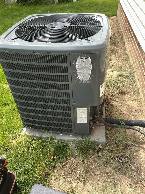 Completed scheduled preventive maintenance on residential split-system air conditioning unit. Performed comprehensive inspection of outdoor condensing unit including visual assessment of cabinet condition, refrigerant line connections, electrical disconnect, and conduit routing. Verified proper unit placement on concrete pad, checked fan operation through protective grille, and confirmed all manufacturer labels and safety warnings were intact and legible. System found operating within normal parameters with no immediate service needs identified.
