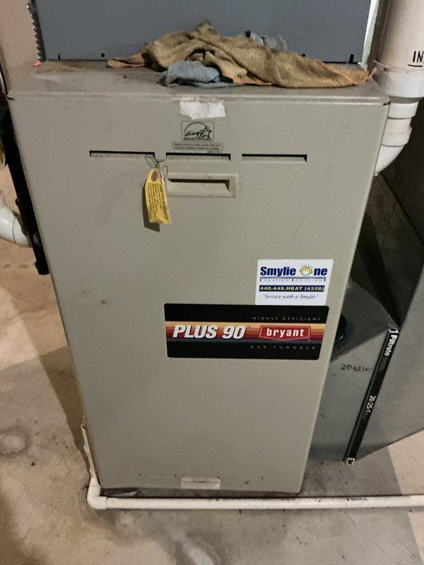 Responded to customer complaint of uneven heating and cooling throughout residence. Performed comprehensive system evaluation on Bryant Plus 90 high-efficiency furnace located in basement utility area. Conducted visual inspection of unit exterior, verified manufacturer labels and service history documentation present on equipment. Assessed overall system condition, noting unit age undetermined but estimated based on model specifications. Inspected ductwork connections, PVC venting system, and mechanical components for proper installation and potential airflow restrictions. Documented equipment model information and current operating configuration with photographic evidence for service records.