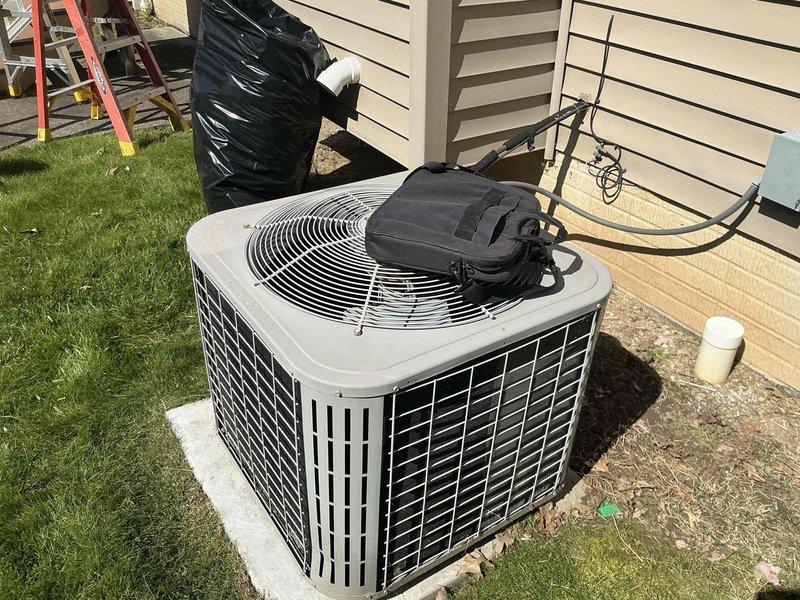 Conducted comprehensive assessment of existing residential HVAC system for replacement estimate. Evaluated outdoor condenser unit positioned on concrete pad adjacent to home exterior, noting refrigerant line routing and electrical connections. Inspected indoor air handler and ductwork configuration in basement utility area, including metal supply ductwork, PVC condensate drainage system, and equipment accessibility for replacement planning. Documented current system layout and provided replacement options for flat-rate pricing consideration.
