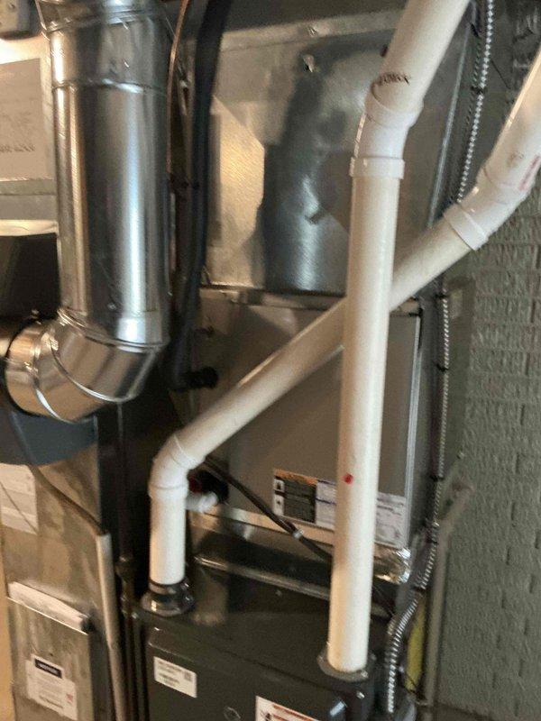 Conducted comprehensive assessment of existing residential HVAC system for replacement estimate. Evaluated outdoor condenser unit positioned on concrete pad adjacent to home exterior, noting refrigerant line routing and electrical connections. Inspected indoor air handler and ductwork configuration in basement utility area, including metal supply ductwork, PVC condensate drainage system, and equipment accessibility for replacement planning. Documented current system layout and provided replacement options for flat-rate pricing consideration.
