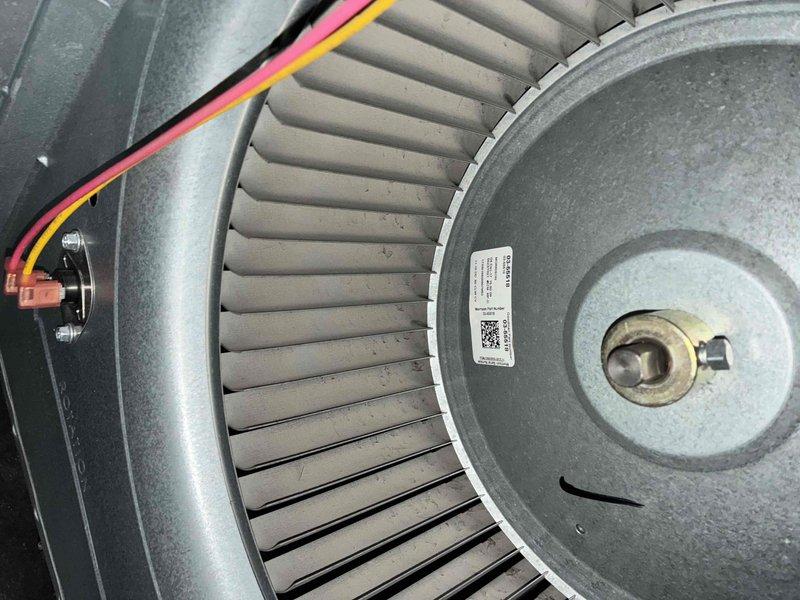 Performed comprehensive cooling system maintenance on HVAC unit. Inspected and documented blower motor assembly, confirming proper operation of squirrel cage fan with all blades intact and motor housing connections secure. Verified electrical connections and wiring at motor terminals. Checked supply and return air vents for proper airflow and clearance, noting standard dust accumulation on components consistent with normal operation.