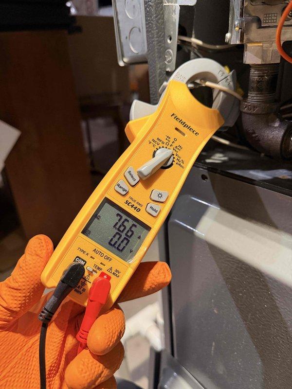 Performed comprehensive cooling system maintenance on outdoor condensing unit. Conducted electrical diagnostics using digital multimeter, verifying control voltage at contactor measured 45.76V and confirming proper wire connections throughout electrical panel. Measured compressor amperage draw at 18.8A using clamp meter, indicating normal operating parameters within manufacturer specifications. All electrical components, wiring connections, and contactors inspected and found in proper working condition with no deficiencies noted.