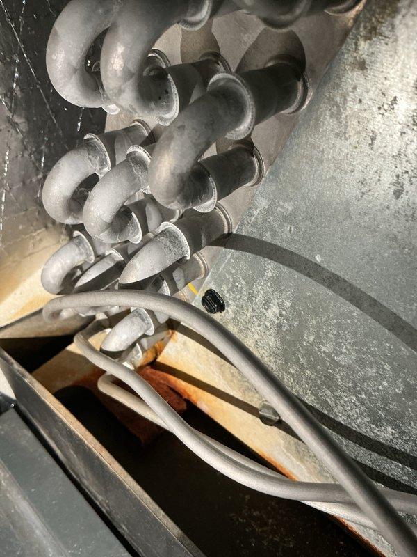 Completed comprehensive cooling system maintenance inspection on residential HVAC unit. Examined refrigerant lines, evaporator coils, and electrical connections within the air handler, confirming proper routing and secure mounting of all components. Inspected exterior condensate drain lines and PVC drainage system for proper operation and clearance from building foundation.