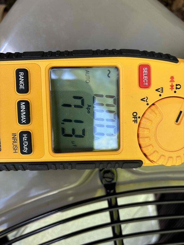 Performed routine cooling maintenance on outdoor condensing unit. Inspected condenser fan assembly, verified proper operation, and documented ambient temperature reading of 23°F using digital multimeter. Fan blades, motor hub, and protective wire guard found in good condition with no visible signs of damage, rust, or deterioration. Unit operating within normal parameters.