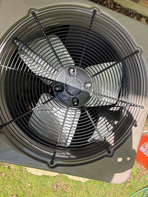 Performed routine cooling maintenance on outdoor condensing unit. Inspected condenser fan assembly, verified proper operation, and documented ambient temperature reading of 23°F using digital multimeter. Fan blades, motor hub, and protective wire guard found in good condition with no visible signs of damage, rust, or deterioration. Unit operating within normal parameters.