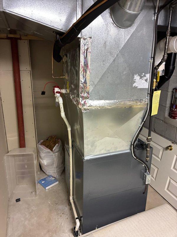 Conducted HVAC equipment evaluation and presented replacement options for existing air handler system in basement mechanical room. Documented current equipment configuration including ductwork connections, existing infrastructure, and installation requirements for potential system upgrade. Assessed mechanical room layout and existing plumbing/electrical components to determine optimal replacement specifications and buyback considerations for the homeowner's decision-making process.