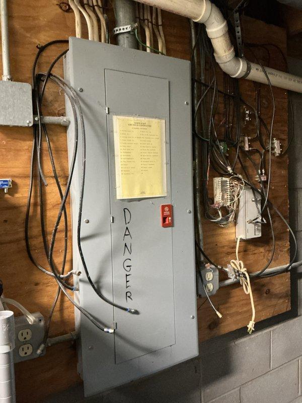 Completed scheduled preventive maintenance on aging residential cooling system. Inspected electrical panel and connections, verified proper power supply to HVAC equipment, and examined all accessible system components. Evaluated and serviced air filtration system, noting dust accumulation on existing triangular filter media within the air handler assembly. Confirmed equipment operational status and documented system condition through photographic records for maintenance history tracking.
