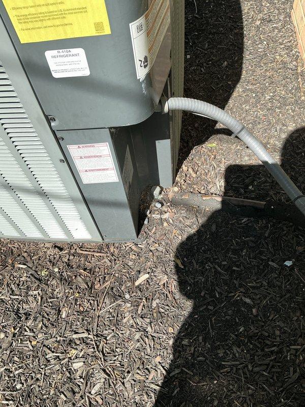 Completed routine cooling system maintenance on residential outdoor condensing unit. Performed comprehensive inspection of P.K. Wadsworth unit including examination of cabinet condition, ventilation louvers, electrical disconnect, and refrigerant lines. Unit found to be in normal operating condition with no visible damage, corrosion, or deterioration present. All components clean and properly maintained with adequate clearance from surrounding landscape materials.