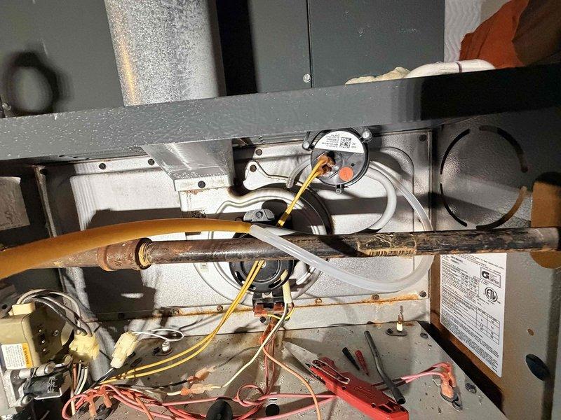 Responded to no heat call on Goodman forced air furnace (Model: GMHB1405DNCC). Upon inspection, unit would not initiate heating cycle. Diagnosed system failure, documented equipment specifications and internal components including blower assembly, refrigerant lines, and electrical connections for service records.