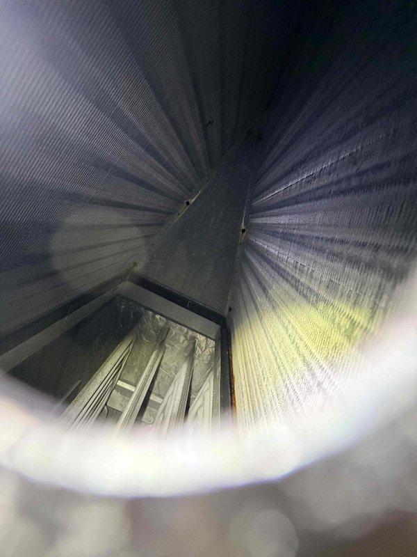 Responded to service call for AC suction line freezing issue. Inspected International Comfort Products furnace unit (Model G8MXN110212042, Serial A181223429) and associated ductwork system. Documented flexible metallic duct interior showing corrugated construction and equipment specifications for diagnostic reference. Freezing suction line typically indicates restricted airflow, low refrigerant charge, or improper system operation requiring further evaluation of evaporator coil, filter condition, and refrigerant levels to resolve the issue.