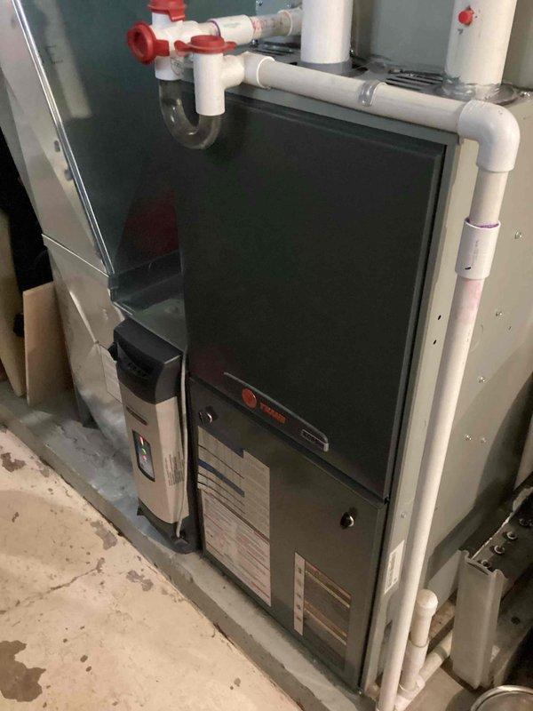 Completed scheduled cooling maintenance on residential Trane HVAC system. Inspected furnace unit, verified proper operation of all components, checked condensate drain trap and drainage system with PVC piping configuration, and confirmed system is functioning within normal parameters for the upcoming cooling season.