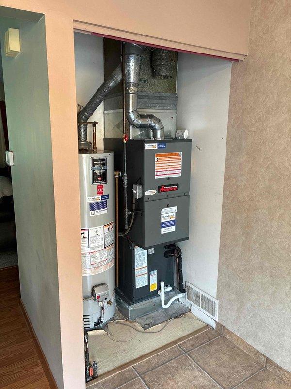 Completed full HVAC system installation including 80% efficiency furnace and air conditioning unit. Installed outdoor condensing unit on level concrete pad with proper refrigerant line connections and electrical service. Mounted indoor furnace/air handler in utility closet with integrated ductwork connections, ensuring proper venting and drainage. System tested and operational.