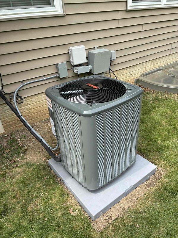 Completed installation of new residential air conditioning system, including outdoor condenser unit (model BRGBH12H) positioned on concrete pad with proper clearances from structure. Connected refrigerant lines to service valves, installed electrical disconnect boxes, and verified all connections are secure and properly insulated.