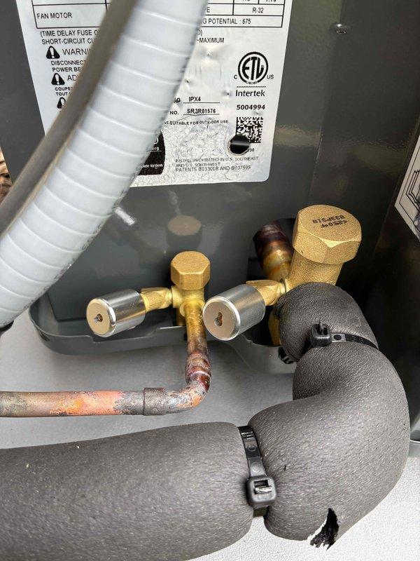 Completed installation of new residential air conditioning system, including outdoor condenser unit (model BRGBH12H) positioned on concrete pad with proper clearances from structure. Connected refrigerant lines to service valves, installed electrical disconnect boxes, and verified all connections are secure and properly insulated.