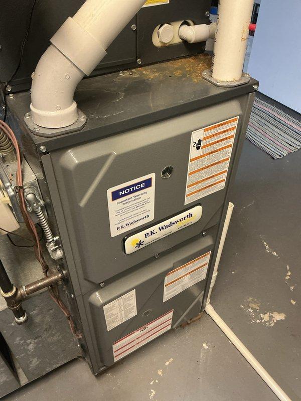 Completed routine HVAC cooling maintenance on residential P.K. Wadsworth furnace and air handler system. Inspected refrigerant lines, condensate drainage system with PVC piping and ball valves, and verified all safety labels and operational components were intact and functioning properly.