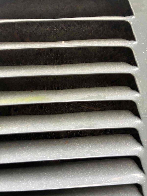 Completed preventive maintenance on two HVAC cooling systems. Inspected evaporator coils on both units, noting moderate dust and debris accumulation between aluminum fins. Examined ventilation grilles and return air vents, observing dust buildup on louvers and slats. Both systems were found to be structurally intact and operational. Documented existing conditions through photographic records for maintenance history files.