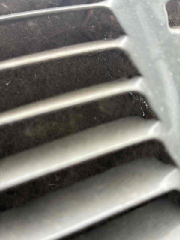Completed preventive maintenance on two HVAC cooling systems. Inspected evaporator coils on both units, noting moderate dust and debris accumulation between aluminum fins. Examined ventilation grilles and return air vents, observing dust buildup on louvers and slats. Both systems were found to be structurally intact and operational. Documented existing conditions through photographic records for maintenance history files.