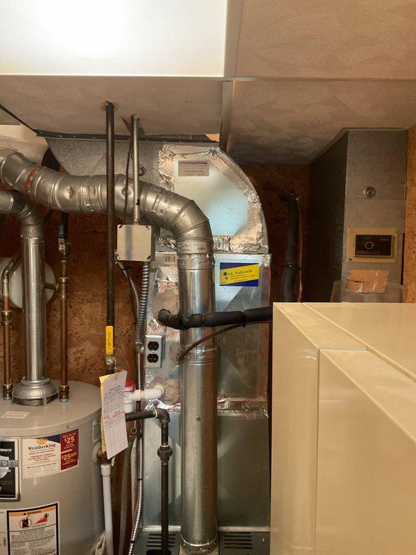 Performed comprehensive cooling system maintenance on residential HVAC unit located in basement mechanical room. Conducted thorough inspection of furnace/air handler assembly, ductwork connections, and associated components. Cleaned and inspected blower assembly through access panel, noting dust accumulation on circular diffuser blades and louvered return grille which were addressed during service. Verified proper operation of all electrical connections at control panel, inspected refrigerant lines and insulated supply ductwork for integrity, and confirmed secure mounting of all mechanical components. System tested and operating within normal parameters upon completion of maintenance procedures.